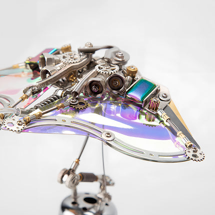 Close-up of the iridescent wings and mechanical head of a metal model kit flying ray, showcasing this unique metallic 3D puzzle / maquette en métal.