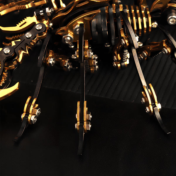  Close-up view of the golden and black legs and body segments of a mechanical scorpion, highlighting the intricate engineering of this metallic 3D puzzle and metal model kit.
