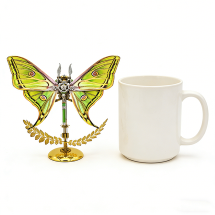 A vibrant steampunk puzzle, a striking mechanical Luna moth with brilliant green and yellow wings, artfully displayed next to a plain white mug to illustrate its size and intricate details. This eye-catching metal model is a prime example of unique mechanical steampunk design, making it an excellent 3D puzzle Metal Kit for hobbyists or a colorful steampunk mech decorative piece for any setting.