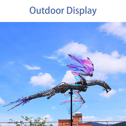 An "Outdoor Display" of the magnificent mechanical dragon Metal Kit with iridescent wings, soaring against a bright blue sky. This impressive DIY 3D puzzle is not just a funny table decor but also a stunning outdoor art piece.