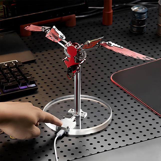 Bionic Mechanical Bird 3D Puzzle Metal Kit - A captivating DIY toy for mechanics and tech enthusiasts, this self-assembled piece showcases a bionic mechanical bird with red metallic wings, featuring electronic components for kinetic movement. Placed on a desk, it serves as a table funny decor, embodying the fusion of bionic engineering and mechanical art, inviting you to craft a dynamic and visually striking piece of bio-mechanical artistry with precision and innovative sensibility.