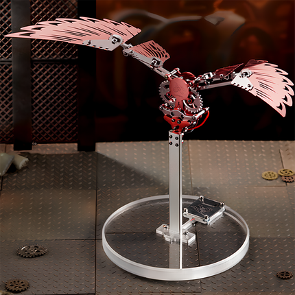 A red mechanical bird metal model with spreading wings and gear mechanisms, featuring a mechanical steampunk design.