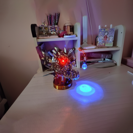 DIY metal model of a steampunk creature with glowing eyes, serving as a cool desk decoration on a funny table