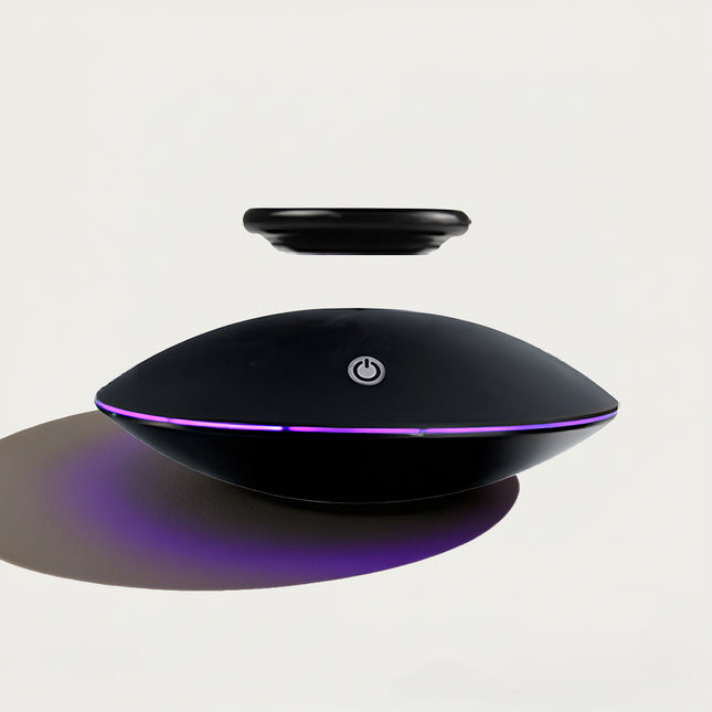 Table Funny Magnetic Levitation Decorative Piece - An innovative creation for tech enthusiasts, design admirers, and novelty decor lovers, this piece from Table Funny features a magnetic levitation decor with a sleek black UFO-shaped base, vibrant purple accent lighting, and a minimalist floating component design. Highlighted by its floating object silhouette, magnetic levitation technology, futuristic aesthetic, and subtle functional detailing (like the power button)