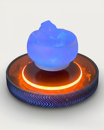 Table Funny Magnetic Levitation Artistic Decor - An innovative creation for design enthusiasts, tech lovers, and novelty decor admirers, this piece from Table Funny features a magnetic levitation decor with a textured circular base, dual-tone accent lighting (vibrant orange and cool blue), and a unique sculptural top piece. Highlighted by its floating artistic silhouette, magnetic levitation technology, contrasting color scheme, and intricate textural detailing