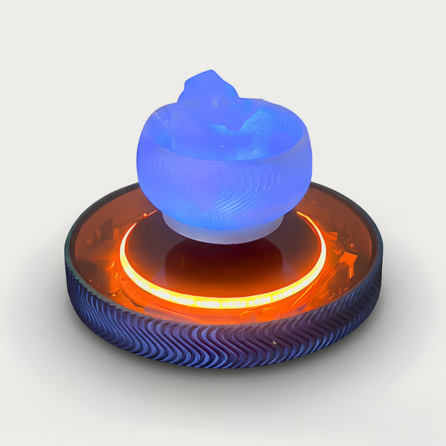 Table Funny Magnetic Levitation Artistic Decor - An innovative creation for design enthusiasts, tech lovers, and novelty decor admirers, this piece from Table Funny features a magnetic levitation decor with a textured circular base, dual-tone accent lighting (vibrant orange and cool blue), and a unique sculptural top piece. Highlighted by its floating artistic silhouette, magnetic levitation technology, contrasting color scheme, and intricate textural detailing