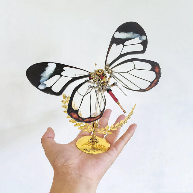 Hand-held steampunk puzzle butterfly metal model with clear wings, a delicate 3D puzzle Metal Kit demonstrating precise mechanical steampunk craftsmanship.