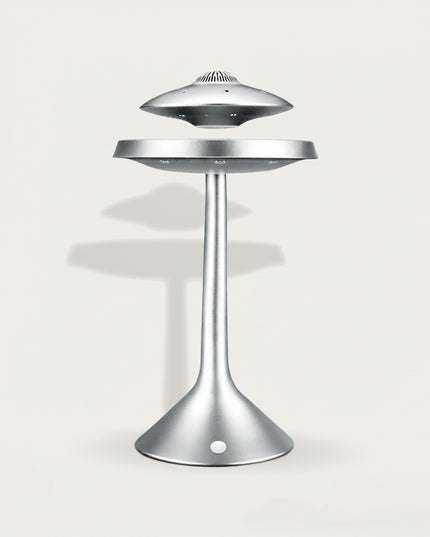Table Funny Magnetic Levitation UFO Decor Piece - A sleek sci-fi decor item for design enthusiasts, futurism fans, and home decor lovers, this is Table Funny’s magnetic levitation UFO-themed piece. It features a matte silver metallic structure, a floating UFO-shaped top (with vent-like details), a suspended mid-platform, and a curved stand base (with integrated magnetic components), paired with a minimalist futuristic aesthetic