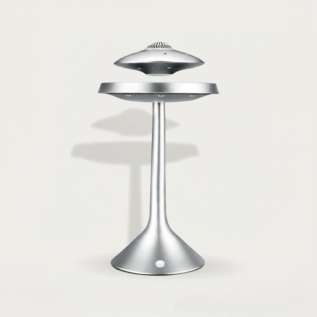 Table Funny Magnetic Levitation UFO Decor Piece - A sleek sci-fi decor item for design enthusiasts, futurism fans, and home decor lovers, this is Table Funny’s magnetic levitation UFO-themed piece. It features a matte silver metallic structure, a floating UFO-shaped top (with vent-like details), a suspended mid-platform, and a curved stand base (with integrated magnetic components), paired with a minimalist futuristic aesthetic