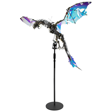 A majestic mechanical dragon Metal Kit with iridescent, colorful wings, posed in flight on a stand. This impressive DIY 3D puzzle is a fantasy-inspired funny table decor piece.