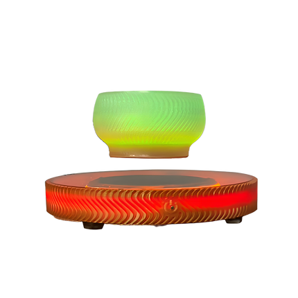 Maglev aromatherapy diffuser, with a levitating green bowl and a glowing red wavy base