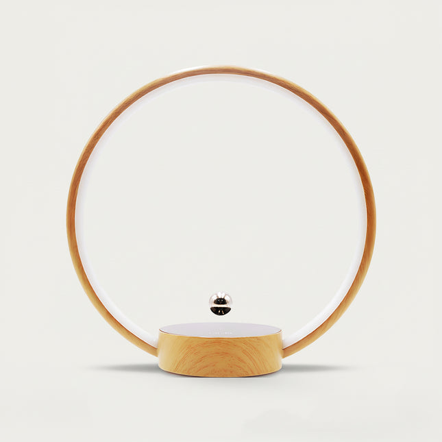 Table Funny Magnetic Levitation Minimalist Decor - An innovative creation for design enthusiasts, tech lovers, and minimalist decor admirers, this piece from Table Funny features a magnetic levitation decor with a wooden circular frame, subtle ambient lighting, and a tiny metallic floating sphere. Highlighted by its floating minimalist silhouette, magnetic levitation technology, clean lines, and natural wood texture integration