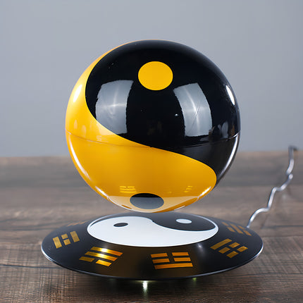 Floating Tai Chi ornament for balance and harmony, featuring a glossy Yin Yang ball and Eight Trigrams base