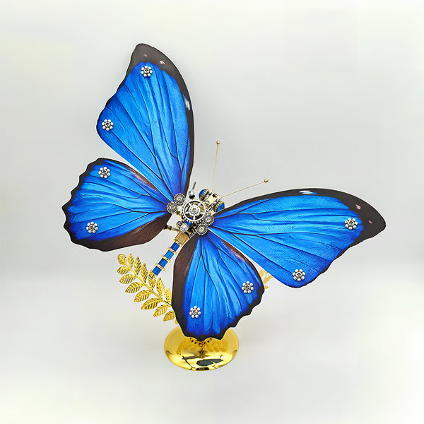 Close-up of a vibrant blue butterfly metal model, a stunning maquette en metal, showcasing its intricate mechanical details and brilliant blue wings adorned with silver accents. This impressive metal model kit is a perfect centerpiece for collectors.