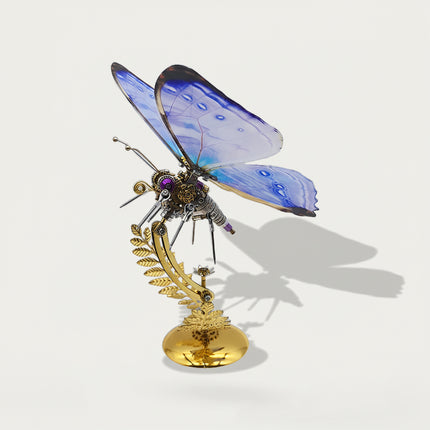 This is a Tablefunny steampunk mechanical butterfly 3D metal puzzle kit: Made of metal, it replicates the butterfly’s form, featuring transparent wings with blue-purple gradient paired with mechanical components like gears and axles, plus a golden fern-shaped base—it’s a creatively designed decorative 3D metal model toy.