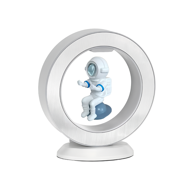 White magnetic levitation desktop display, featuring an astronaut model suspended within a ring floating atop a matching-color base — magnetic levitation ornament