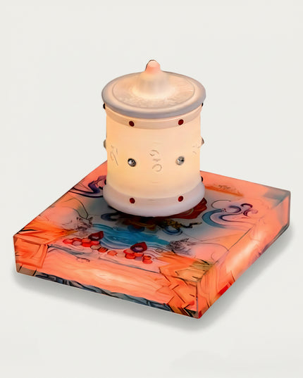 Table Funny Magnetic Levitation Zen Lamp Artwork - A distinctive creation for cultural enthusiasts, spiritual seekers, and decor admirers, this piece from Table Funny features a magnetic levitation zen lamp with a vividly colored, artfully illustrated base inspired by Tibetan art, a luminous white prayer wheel-inspired design with red accents and engraved spiritual symbols, and a thematic spiritual design. Highlighted by its floating, glowing zen-inspired silhouette, magnetic levitation technology