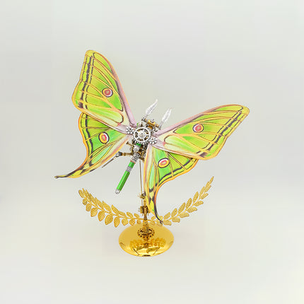 Close-up of assembled 3D puzzle metal kits - steampunk moth metal model, DIY funny table craft with exposed green-silver gear mechanisms & delicate wire antennae