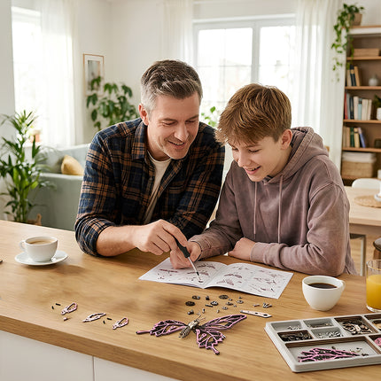 A father teaching his son how to build a pink mechanical steampunk butterfly following the DIY instruction manual.