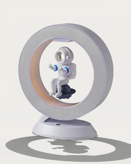 Table Funny Magnetic Levitation Astronaut Artwork - An innovative creation for space enthusiasts, tech lovers, and design admirers, this piece from Table Funny features a magnetic levitation astronaut decor with a sleek circular frame, warm ambient lighting, and a detailed astronaut design. Highlighted by its floating astronaut silhouette, magnetic levitation technology, space-themed aesthetic, and modern structural design, it’s a captivating decor piece that merges space art, technological innovation 