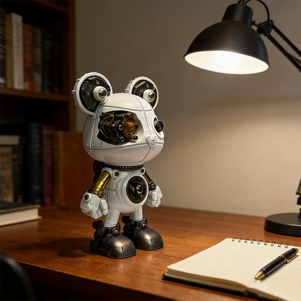 A charming steampunk mech bear robot maquette en metal with white and gold accents, featuring visible gears and mechanisms. It stands on a wooden desk under a task lamp, beside a notebook and pen, representing a delightful 3D metal model kit and steampunk puzzle.