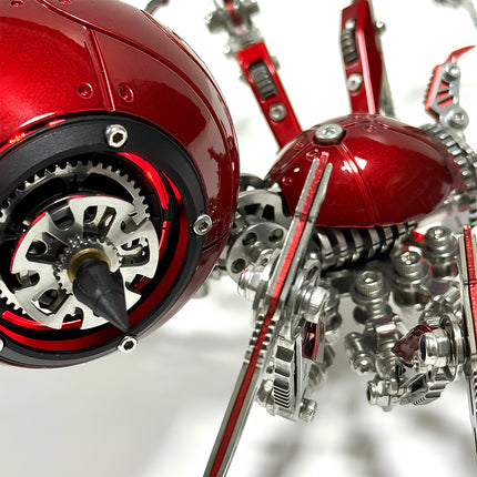 Close-up of the red mechanical spider metal model's main body, highlighting its glowing gears, sharp details, and polished red metallic surface. This 3D puzzle metal kit showcases intricate mechanical steampunk artistry, making it a unique steampunk puzzle.