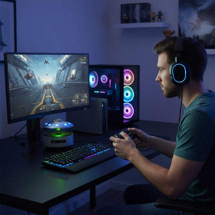 The magnetic levitation Bluetooth speaker floats above a color-changing galaxy base, displayed on a gaming desk featuring an RGB case and keyboard—a perfect blend of gamer ambiance and creative gifting