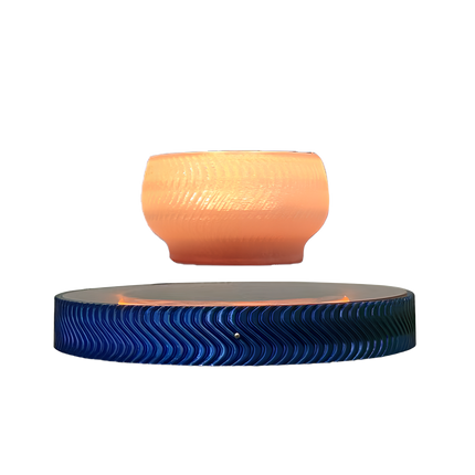 Maglev aromatherapy diffuser, with a glowing textured top, suspended above a wavy blue base