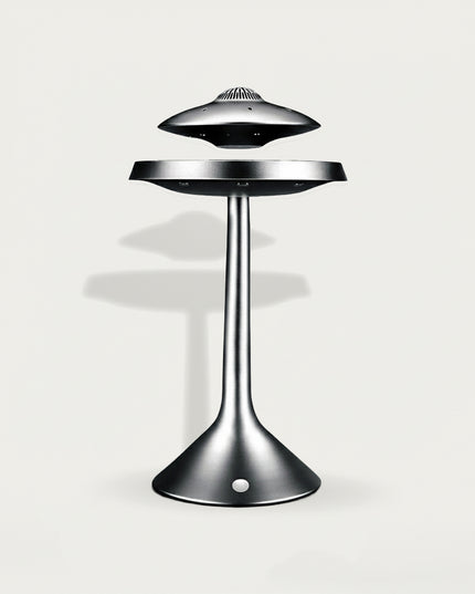 Table Funny Magnetic Levitation UFO Speaker - A futuristic audio creation for tech enthusiasts, industrial design lovers, and decor admirers, this piece from Table Funny is an elaborate magnetic levitation UFO speaker (with functional audio features). It features a matte silver metallic structure, a levitating UFO-shaped speaker top (with vent details for audio output), a suspended mid-platform, and a curved stand base (integrated with magnetic & audio components)