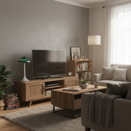 The magnetic levitation Bluetooth speaker rests atop a silver pillar base with a green halo, placed on the TV stand within a cozy living room