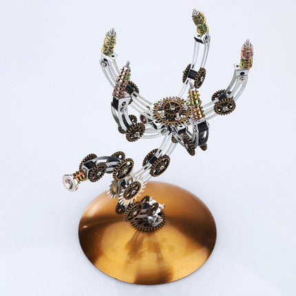 Intricate mechanical steampunk 3D puzzle metal kit resembling a scorpion or spider, standing on a bronze base. This unique steam punk mech features numerous visible gears, springs, and articulated metal components, perfect for a challenging steampunk puzzle.