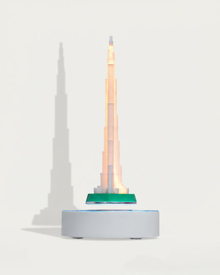 able Funny Magnetic Levitation Iron Tower Artwork - An innovative creation for architecture lovers, tech enthusiasts, and design admirers, this piece from Table Funny features a magnetic levitation model of the Iron Tower with a sleek white base, warm LED lighting, and a realistic architectural design. Highlighted by its precise structural detailing, floating landmark silhouette, magnetic levitation technology, and striking shadow effects