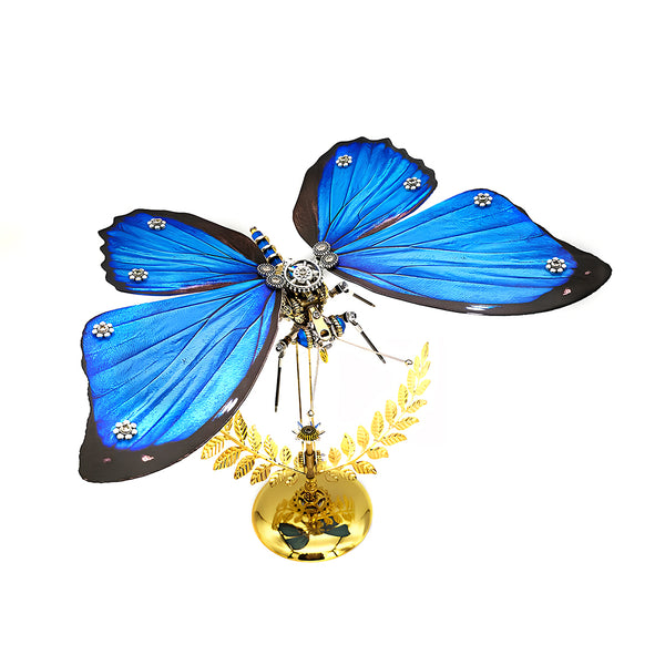 Stunning blue butterfly metal model kit with intricate mechanical details and brilliant blue wings, displayed on a decorative golden stand with laurels. A captivating metal 3D puzzle and artistic maquette en metal.