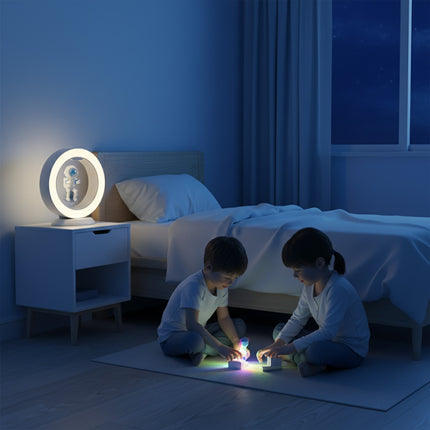 Two children played on the bedroom floor at night, while a warm white magnetic levitation astronaut nightlight floated above the nightstand. Inside the ring-shaped lamp, an astronaut figurine hovered