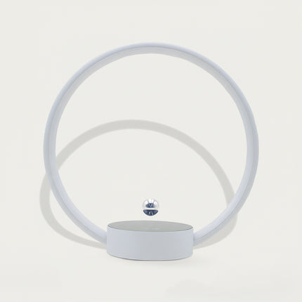 Table Funny Magnetic Levitation Minimalist Decor - An innovative creation for design enthusiasts, tech lovers, and minimalist decor admirers, this piece from Table Funny features a magnetic levitation decor with a light gray circular frame, subtle ambient lighting, and a tiny metallic floating sphere. Highlighted by its floating minimalist silhouette, magnetic levitation technology, clean lines, and soft monochromatic design