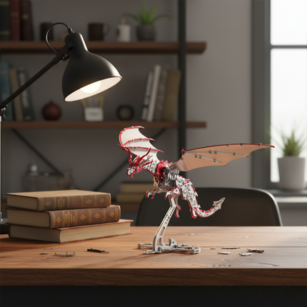 A stunning red and silver DIY 3D puzzle Metal Kits dragon metal model proudly displayed on a wooden desk, illuminated by a task lamp. This intricate metal model makes a fantastic funny table decoration, adding character to any study or office space