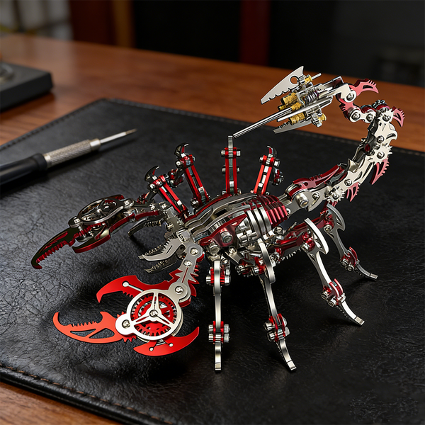  A sleek red and silver steampunk mech scorpion maquette en metal with intricate details, displayed on a black leather desk mat next to a precision screwdriver. This advanced 3D metal model kit is a challenging steampunk puzzle for enthusiasts.