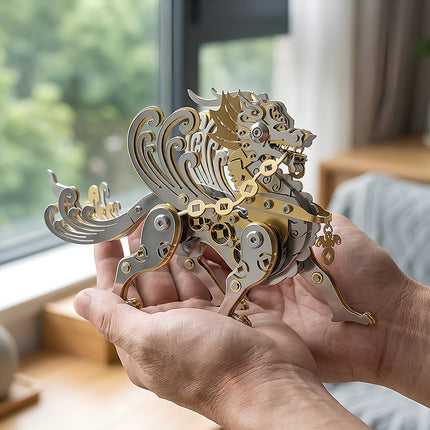 Hands holding a finished mythical dragon metal model, showcasing the intricate gold and silver details of this 3D puzzle Metal Kits.