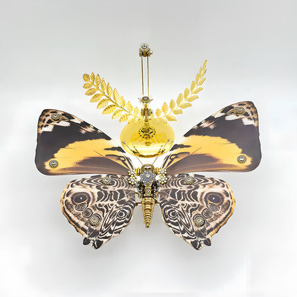 A breathtaking overhead view of a stunning steampunk puzzle, a magnificent mechanical butterfly with wide, distinctive brown and yellow patterned wings, showcased majestically above an ornate golden stand with laurel details. This symmetrical metal model highlights profound mechanical steampunk design, making it an impressive 3D puzzle Metal Kit for hobbyists or a captivating steampunk mech display piece that embodies intricate beauty and advanced engineering from above.
