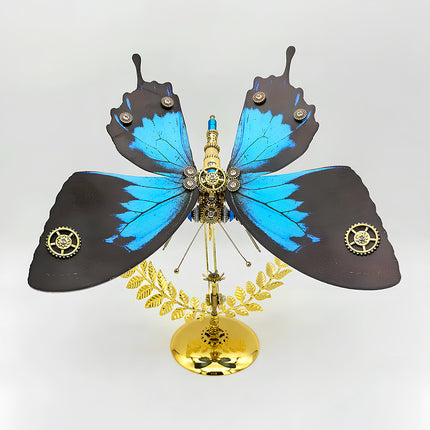 A stunning frontal view of a steampunk puzzle, this mechanical butterfly showcases wide, vibrant blue and black patterned wings with intricate gear details on a golden stand. This symmetrical metal model highlights profound mechanical steampunk design, making it an impressive 3D puzzle Metal Kit for hobbyists or a captivating steampunk mech display piece that truly embodies artistic engineering and visual appeal.