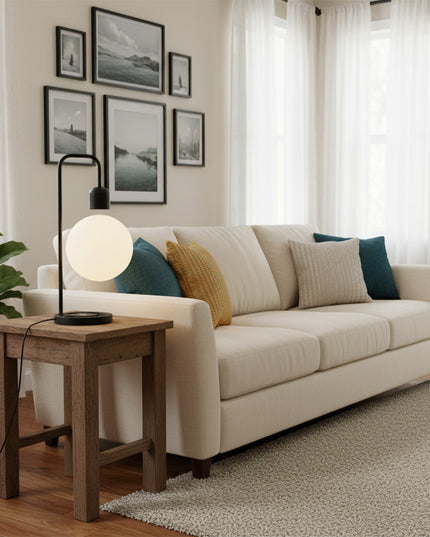 Magnetic levitation spherical table lamp with a black curved stand, placed on a wooden side table—providing warm bedside and living room ambient lighting for minimalist-style homes.