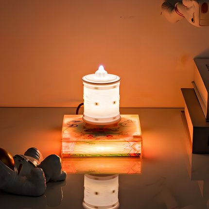 Magnetic levitation aroma diffuser emitting a warm glow, creating a peaceful and fragrant atmosphere in a cozy setting