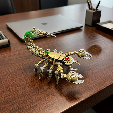 Close-up of a steam punk mech scorpion metal model featuring intricate brass gears and a metallic stinger on a wooden desk.