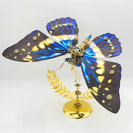 A magnificent frontal view of a steampunk puzzle, a mechanical butterfly with wide, vibrant blue, yellow, and black patterned wings and an intricate gold and silver body, prominently displayed on a gleaming golden stand against a clean background. This symmetrical metal model highlights sophisticated mechanical steampunk design, making it an impressive 3D puzzle Metal Kit for hobbyists or a striking steampunk mech display piece that showcases its captivating coloration and detailed craftsmanship.