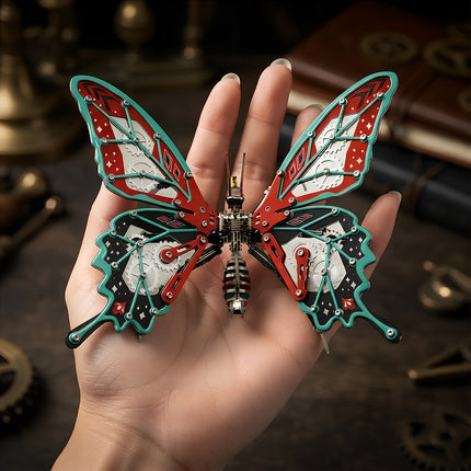 A colorful 3D metal mechanical butterfly model with visible gears held flat in the palm of a hand.