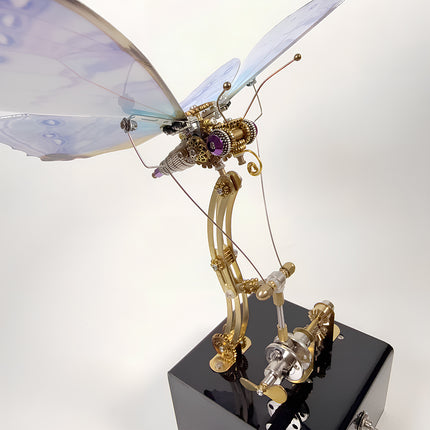 Extreme close-up of the brass gears, rods, and mechanism of an assembled 3D metal mechanical butterfly model puzzle.