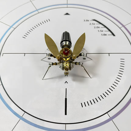 Front-facing view of a mechanical steampunk fly 3D puzzle metal kit on a white measurement mat, showcasing its golden wings, detailed mechanical body, and a prominent dark, segmented abdomen. This steampunk puzzle is a fascinating build.