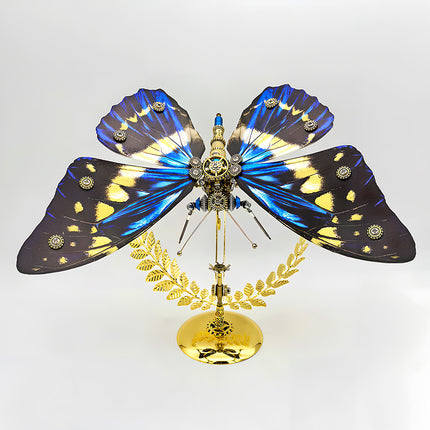 A magnificent frontal view of a steampunk puzzle, a mechanical butterfly with wide, vibrant blue, yellow, and black patterned wings, prominently displayed on an ornate golden stand against a clean background. This symmetrical metal model highlights sophisticated mechanical steampunk design, making it an impressive 3D puzzle Metal Kit for hobbyists or a striking steampunk mech display piece that showcases its captivating coloration and detailed craftsmanship.