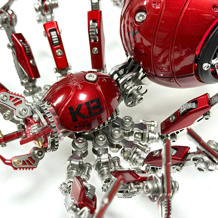 Intricate red steampunk puzzle spider with gleaming metal kit parts, highlighting the sophisticated mechanical steampunk design. An engaging 3D puzzle metal model for enthusiasts.