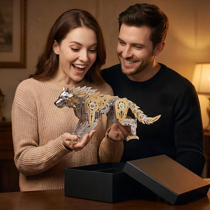 A smiling woman unboxing a gold and silver 3D metal mechanical wolf model gift from a black box with her partner.